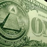 Low angle, shallow depth of field shot of pyramid, from the great seal, on the back of the US dollar bill.